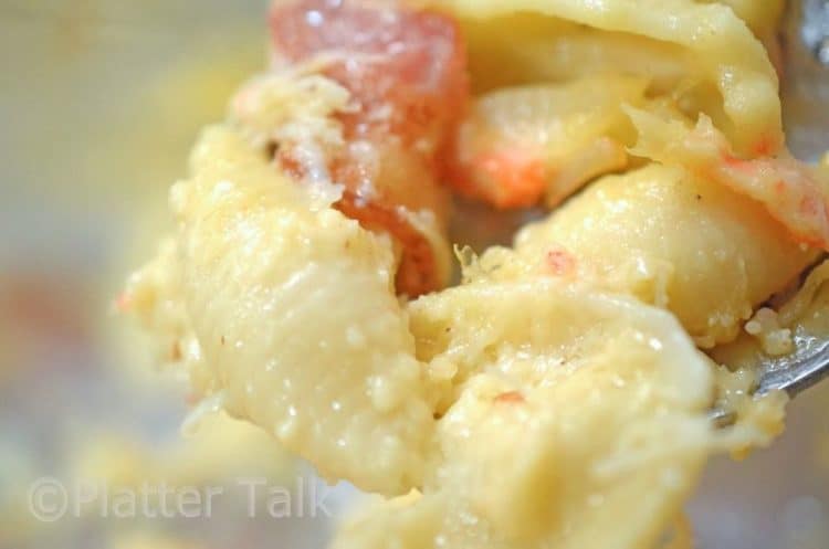 forkful of macaroni and cheese with crab meat.
