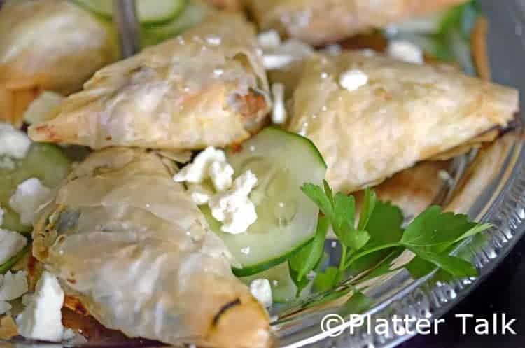 A close-up of a plate of food, with Spanakopita.