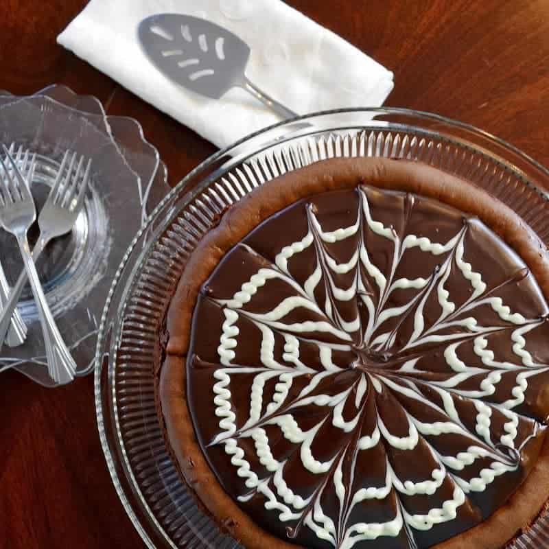 A close up of a bowl on a table, with chocolate cheesecake