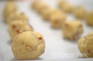 pecan sandies rolled on a cookie sheet