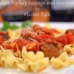 A close up of a plate of pasta with Sausage