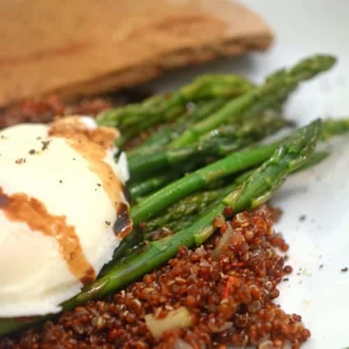 A close up of a plate of food with asparagus.