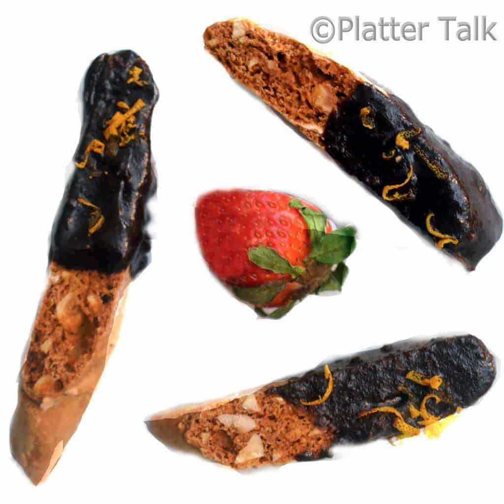 three hazelnut biscotti with a strawberry