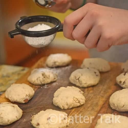 powdered sugar getting dusted over cookies