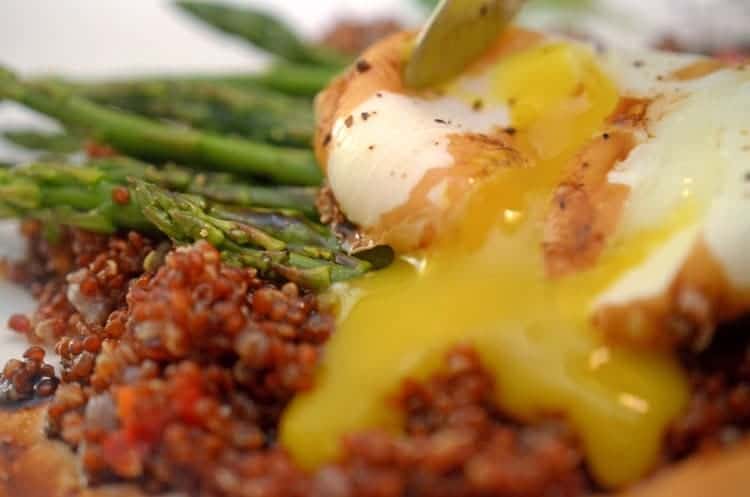 A close up of a plate of food with a poached egg.