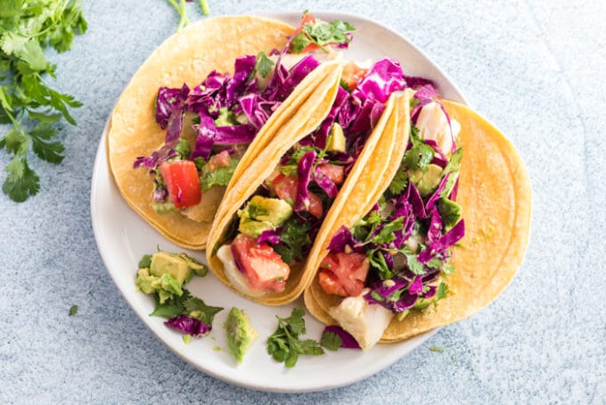 Serving plate of three mahi-mahi fish tacos.