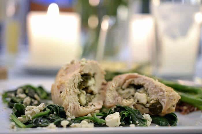 A close up of a spinach and feta chicken rollup 