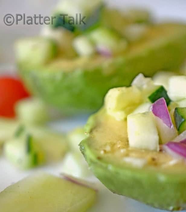 A close up of cuke salad, with avocado 