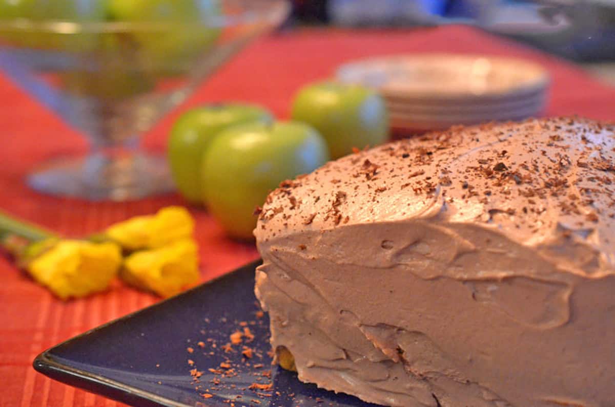A cake with chocolate pudding and cool whip frosting.