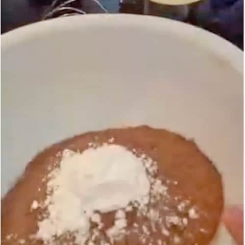 A mixing bowl with instant pudding and powdered sugar in it.
