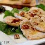 a plate of honey pecan pork chops