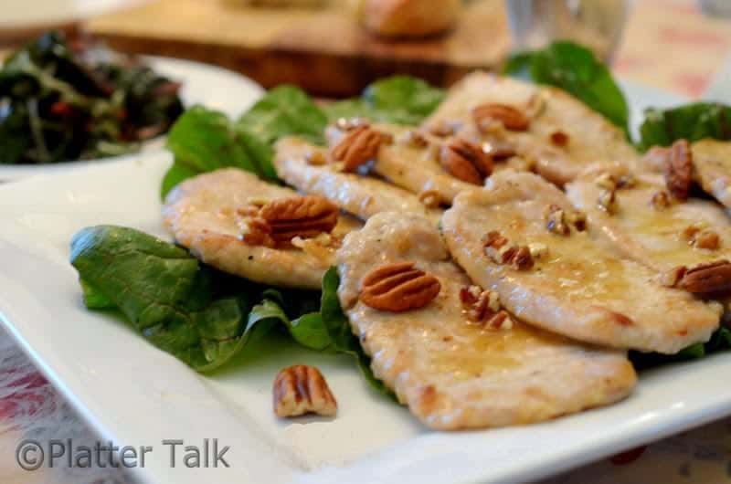 a plate of honey pecan pork chops