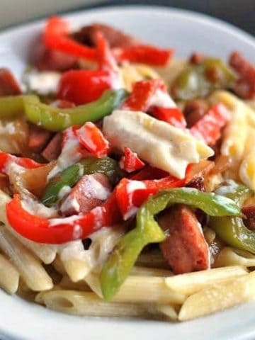 A plate of smoked sausage penne alfredo