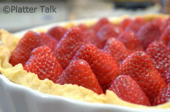 A close up of a strawberry pie