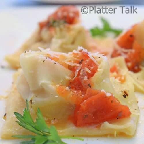 a close up of wonton wrapped sausage and ricotta ravioli 