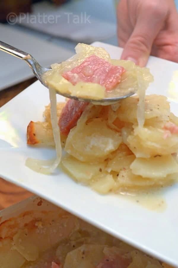 a close up of scalloped potatoes and ham