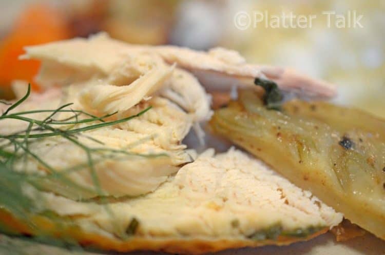 chicken getting brushed with herb butter