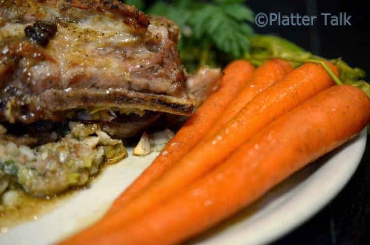 A plate with ribs and carrots.