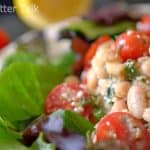 a close up of a white bean cherry tomato salad