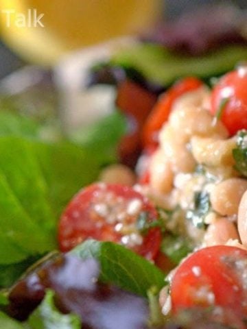 a close up of a white bean cherry tomato salad