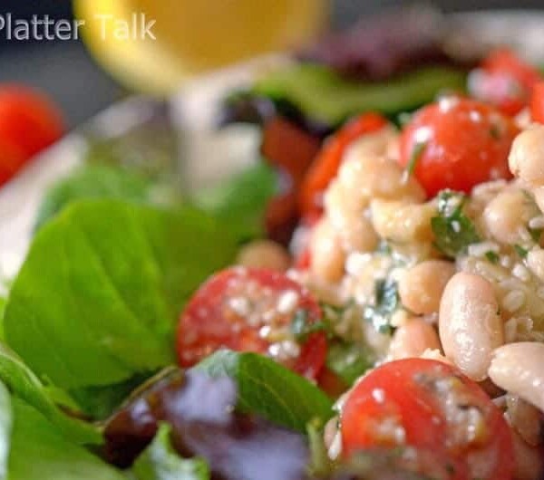 a close up of a white bean cherry tomato salad