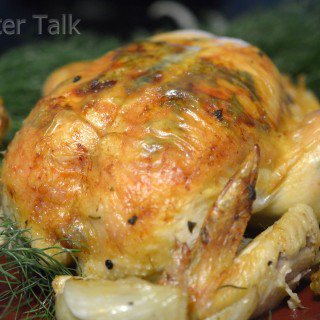 A whole chicken on a plate.