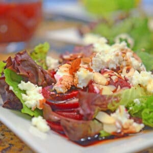 A green leafy salad with pickled beets and goat cheese.