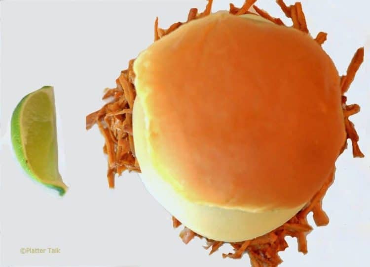 A pulled pork sandwich on a plate.
