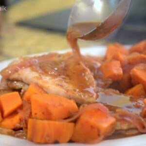 A plate of pork with gravy.