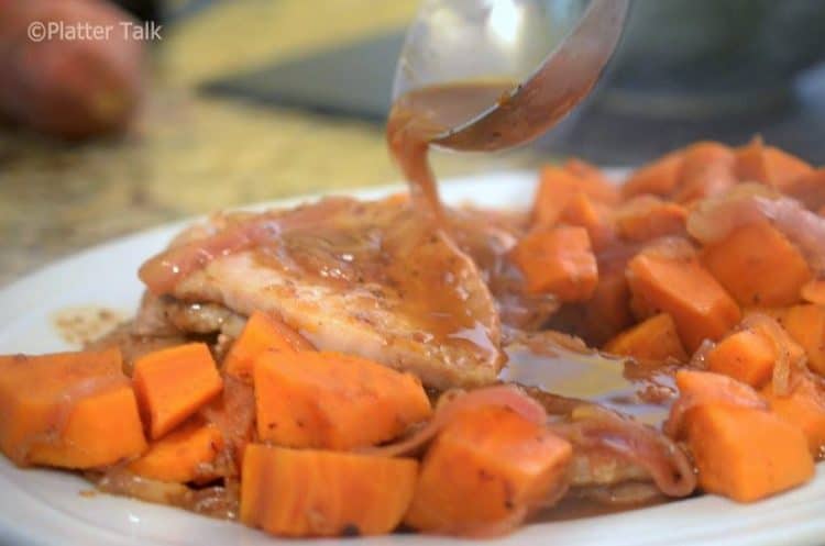 A plate of pork with gravy.