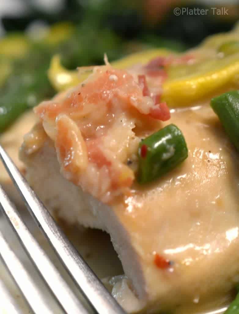 A close up of a plate of food with Chicken.