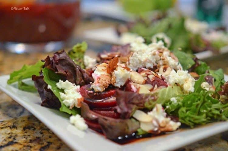 A plate of beet salad with goat cheese.