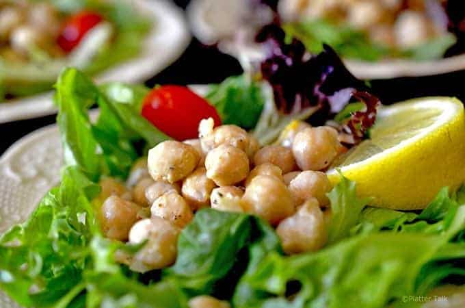 A close up of a plate of salad, with Hummus salad and Chickpea