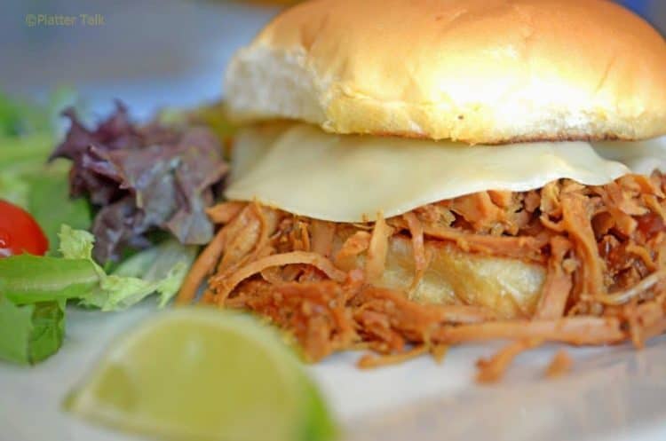 A close-up of a pulled pork sandwich.