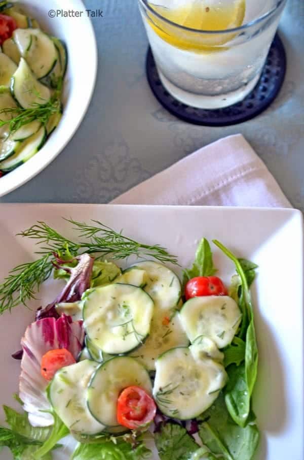 A plate of salad with cucumbers.