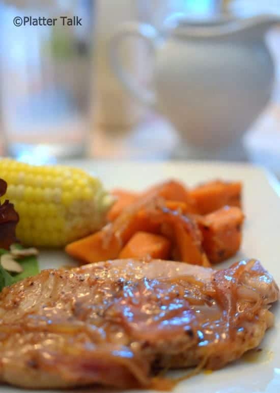 A close-up of a plate of pork and potatoes.