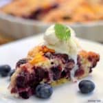 a slice of blueberry and peach yogurt streusel with ice cream