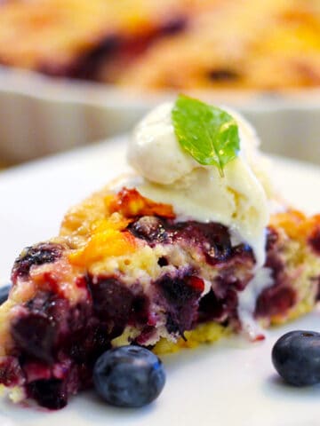 A slice of blueberry buckel on a plate.