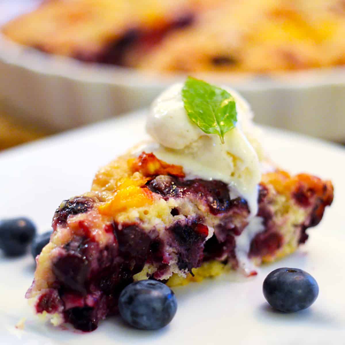 A slice of blueberry buckel on a plate.