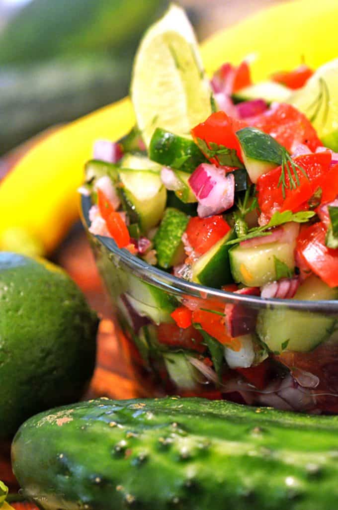 A bowl of vegetable salad, with Salsa and Cucumber