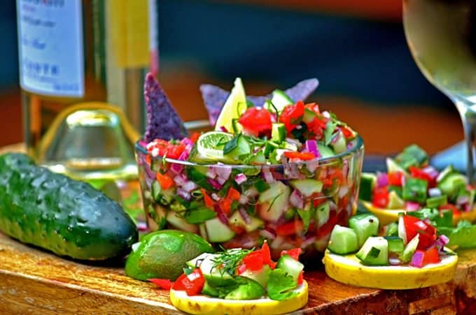 Food on a table, with Salsa and Cucumber