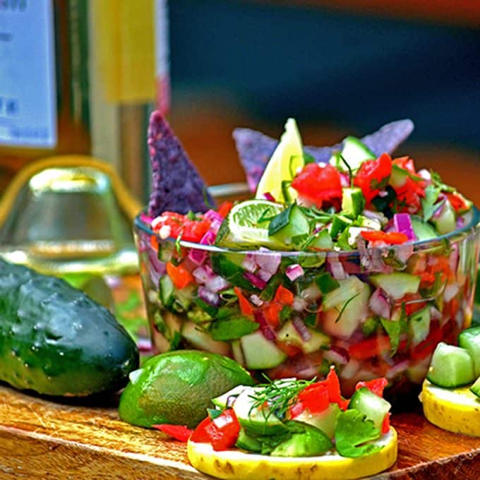 Food on a table, with Salsa and Cucumber