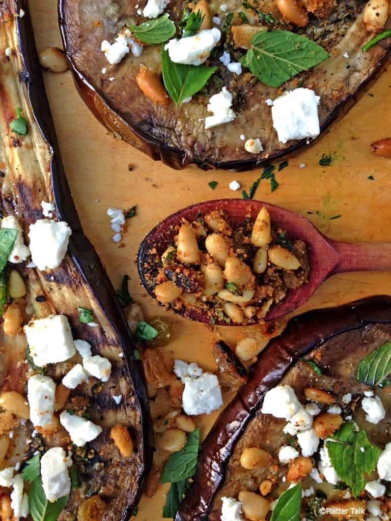 A plate of food with a slice of Eggplant.