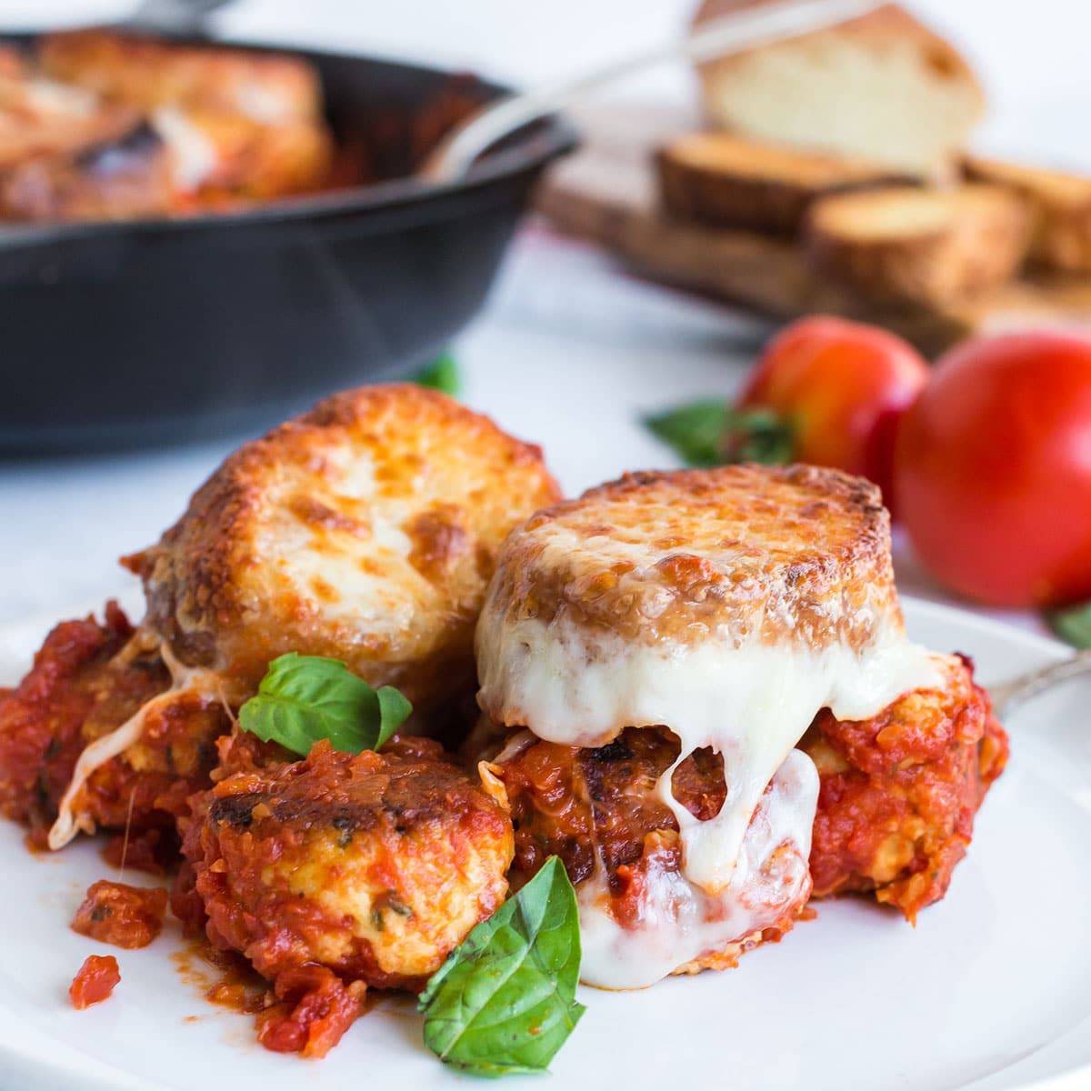 Plate of meatbasll sub casserole with basil garnish