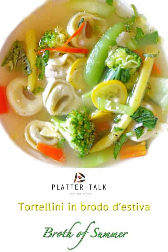 A bowl of soup with broccoli and Tortellini.