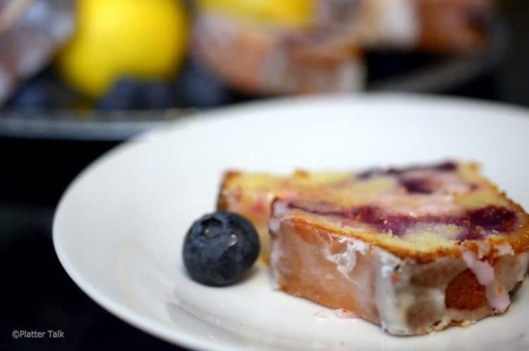 A close up of a slice of blueberry bread.