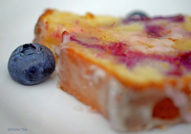 A close up of a piece of blueberry bread.