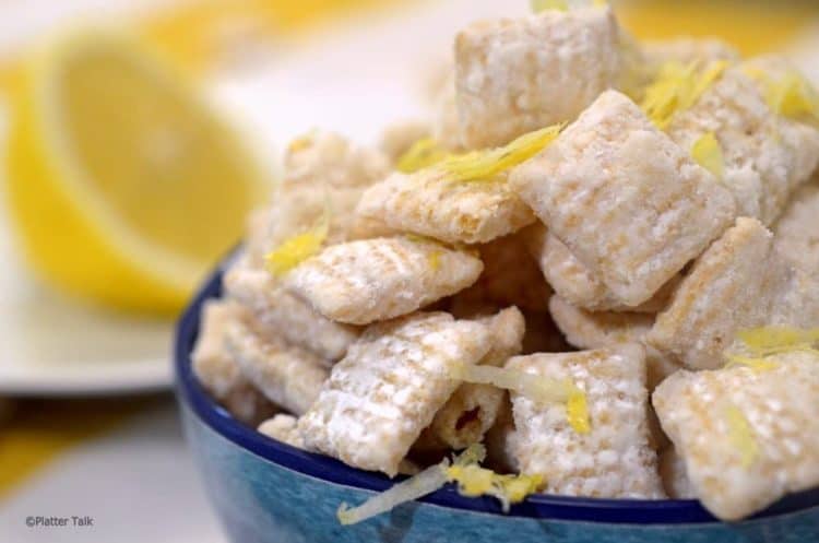 A bowl of food on a plate, with Lemon.