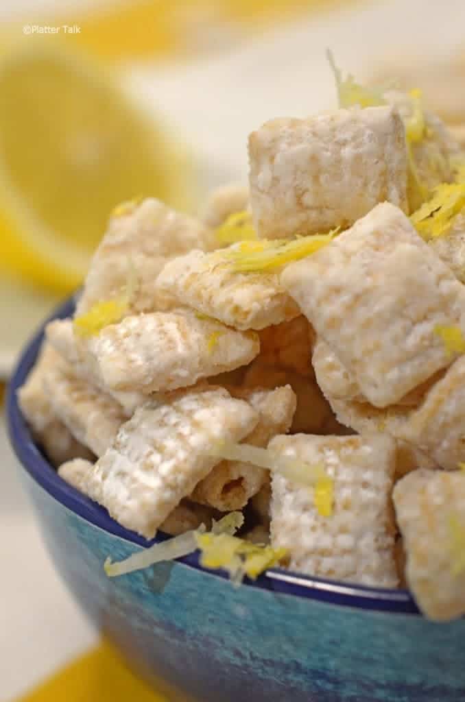 A bowl of food on a plate, with Lemon.