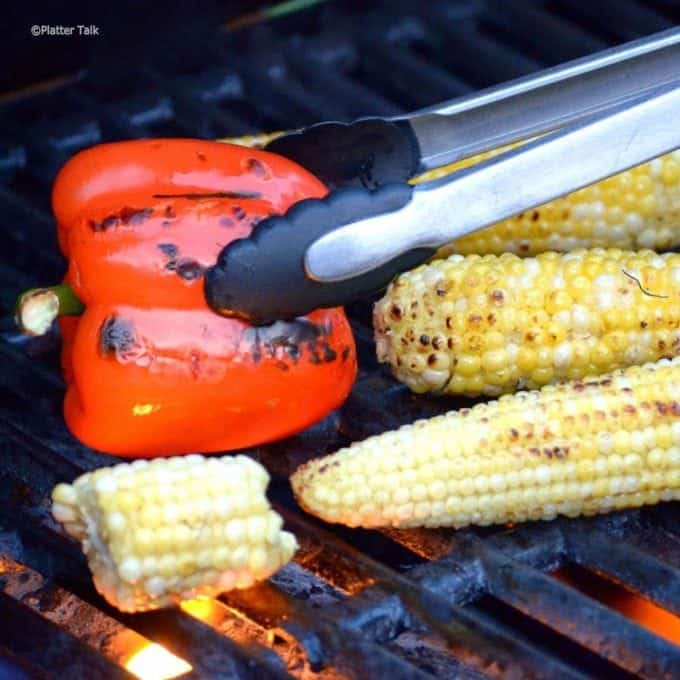 A roasted bepper and corn on the cob on the grlll